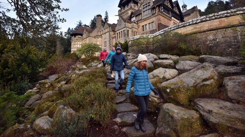 Visitors descending a path through the Rock Garden at Cragside, Northumberland